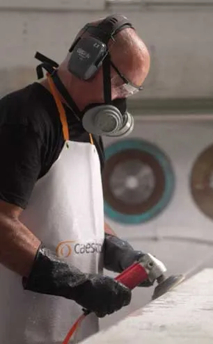 Caesarstone Master of Stone Porcelain Fabrication and Installation Guide cover with fabricator working on a porcelain surface