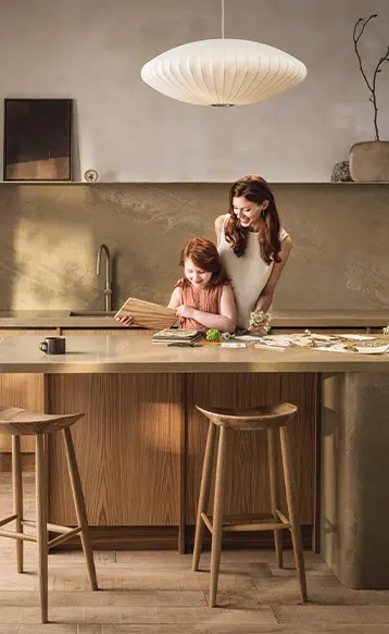 Mother and daughter standing in the kitchen near a Caesarstone mineral surface